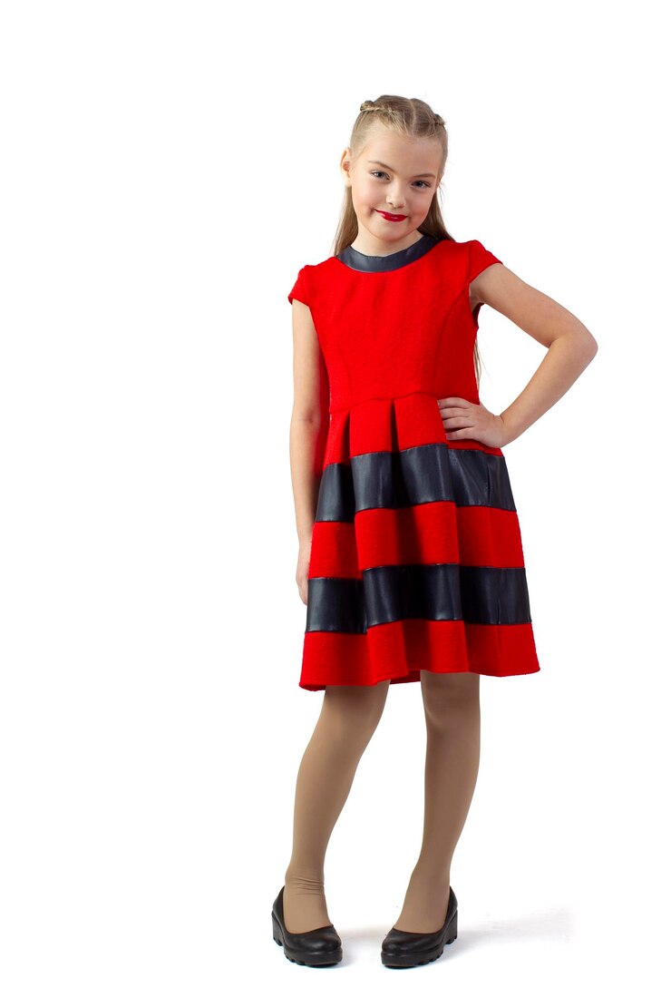 Funny teen girl in a red dress on a white background Little fashionista with red lipstick