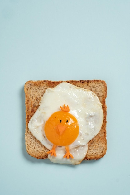 Funny toast with fried eggs in a shape of chicken