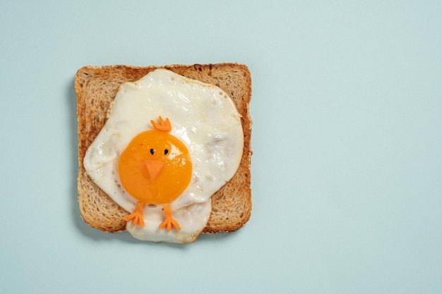 Funny toast with fried eggs in a shape of chicken