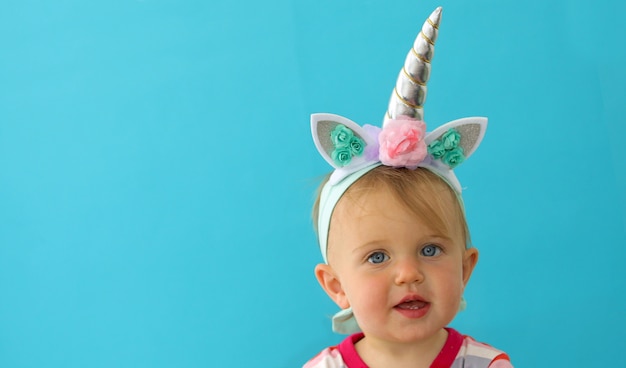 Funny unicorn little girl on blue