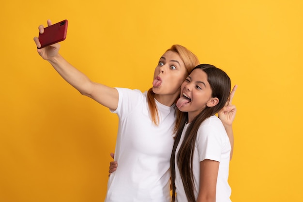 Funny woman and girl take selfie with mobile phone. selfie family. modern life. mobile technology