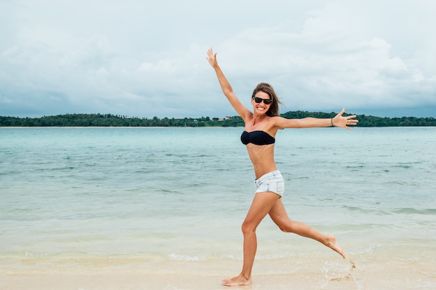 Funny woman playing on the beach