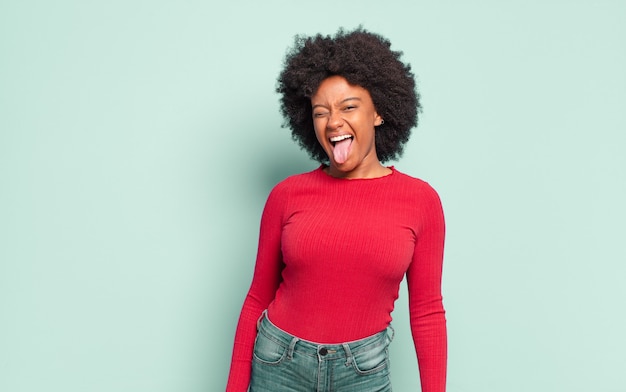 Funny young pretty black woman sticking out her tongue