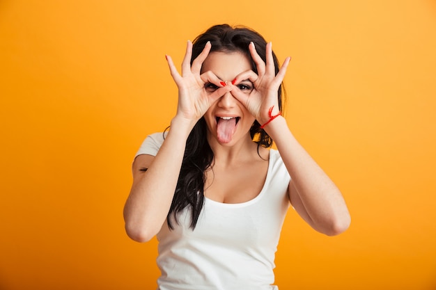 Funny young woman showing okay gesture