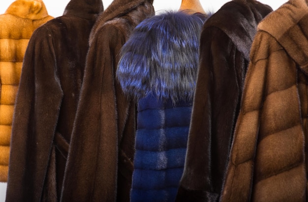 Photo fur coats on hangers in the interior