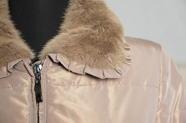 Photo fur collar on a warm womens beige jacket with zipper