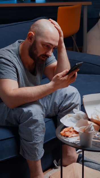 Furious nervous frustrated overdue young man receiving bad news from bank