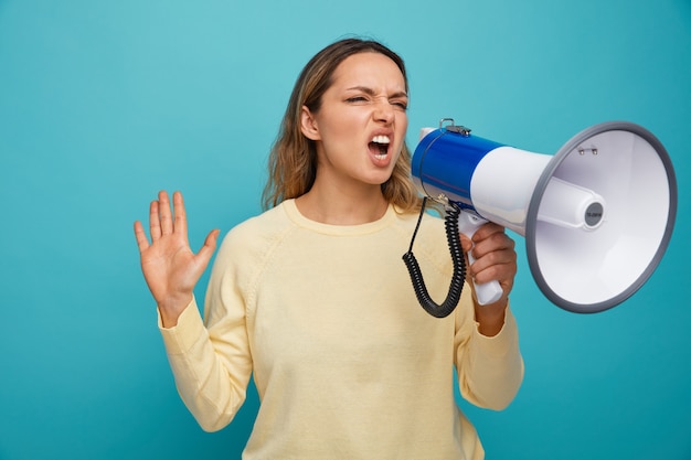 Photo furious young girl looking at side shouting in loud speaker doing refusal gesture