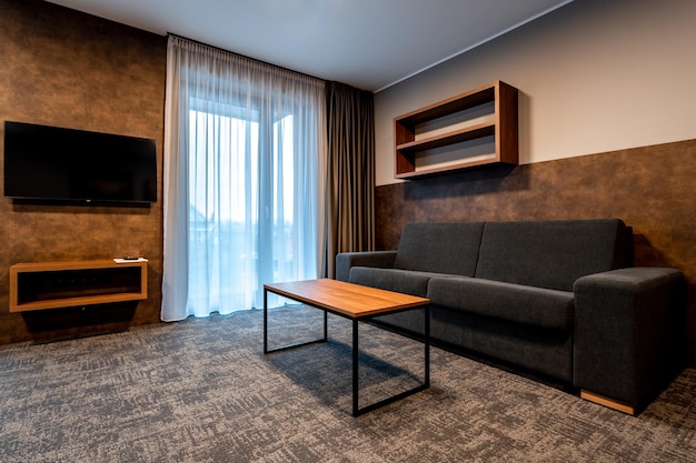 Furniture in the hotel room sofa set with coffee table and TV