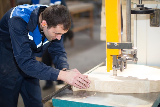 Furniture manufacturing open day carpenter makes furniture with
a machinefurniture factory