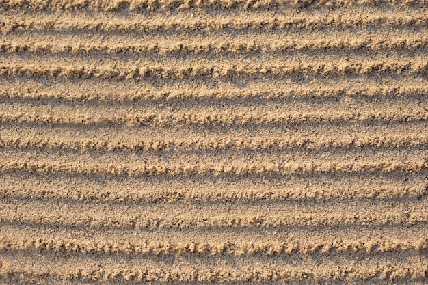 Furrows in the sand after leveling.