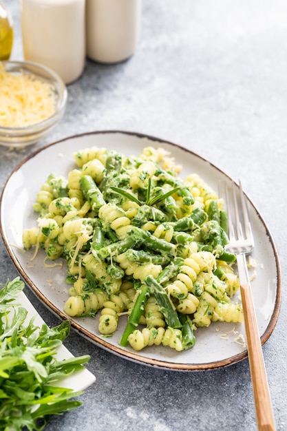 Fusili pasta with green vegetables and creamy sauce