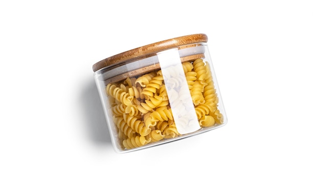Fusilli pasta in a glass jar isolated.