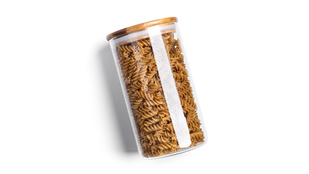 Fusilli pasta in a glass jar isolated.