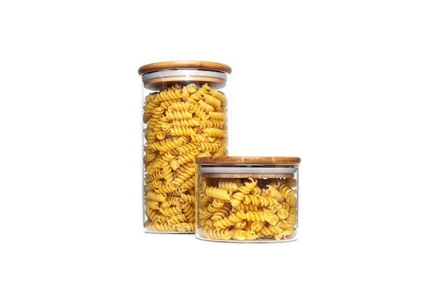 Photo fusilli pasta in a glass jar isolated.