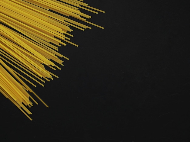 Fusilli and Spaghetti pasta on a black background