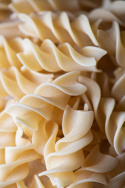 Photo fusilli twisted pasta macrophotography background