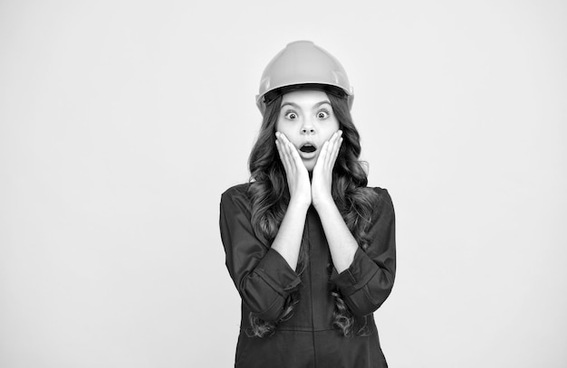 Future engineer making repairs surprised teen girl in protective hard hat