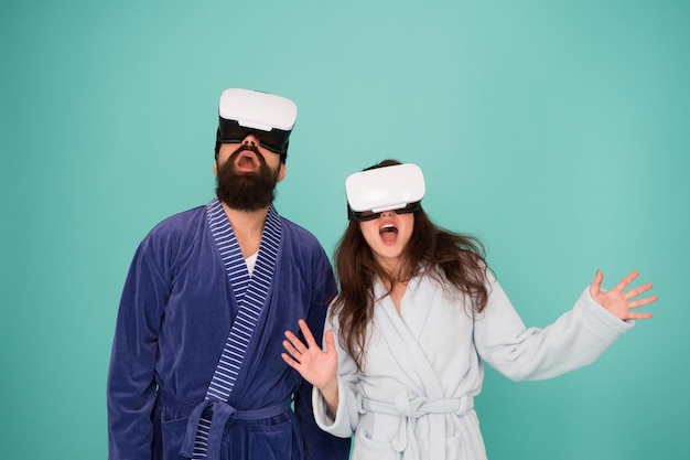 Future life. Good morning. Couple in love. Family. Virtual reality. Love. Happy family in vr glasses. Bearded man and woman in robe pajama. Future is now. Future technology. Vr glasses is our future.