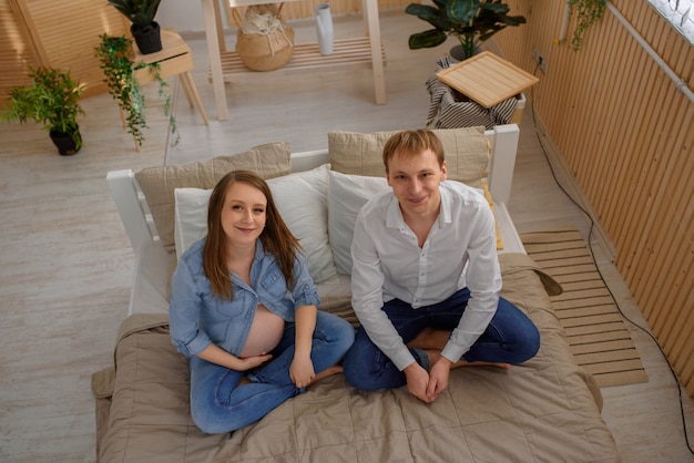  future parents on the bed shot from the top angle