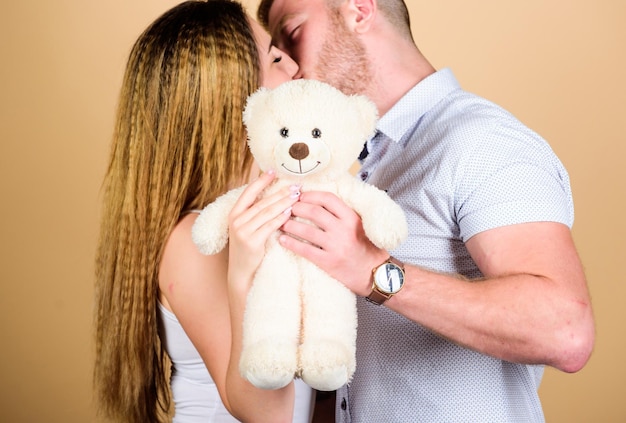 Future parents Family love Man and pretty girl in love Guy and girl cuddling Happy family Valentines day holiday Soft toy teddy bear gift Pregnancy concept Man and woman couple in love