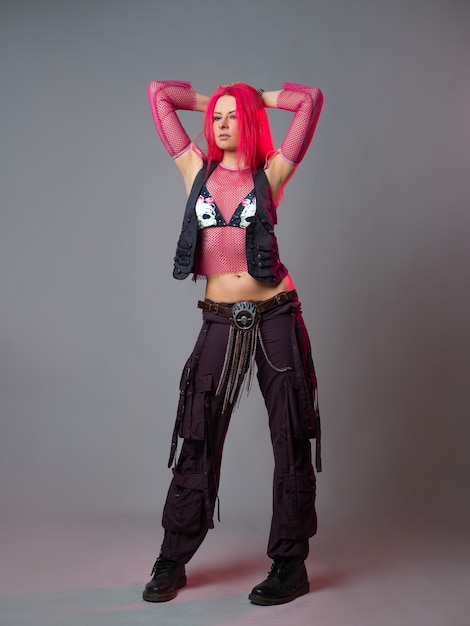 Futuristic fashion a young bright and attractive woman with pink hair