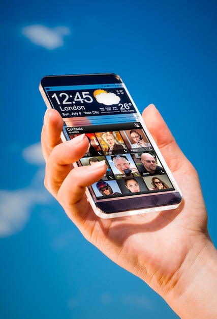 Photo futuristic smart phone (phablet) with a transparent display in human hands. concept actual future innovative ideas and best technologies humanity.