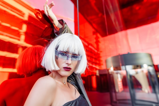 Futuristic style. Woman with glasses and near a red futuristic building