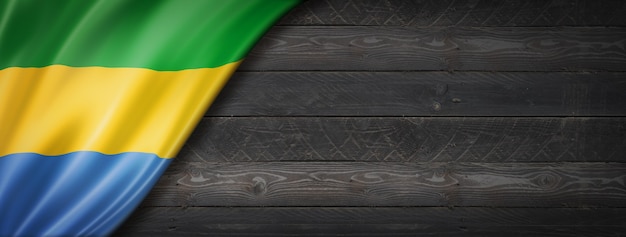 Gabon flag on black wood wall