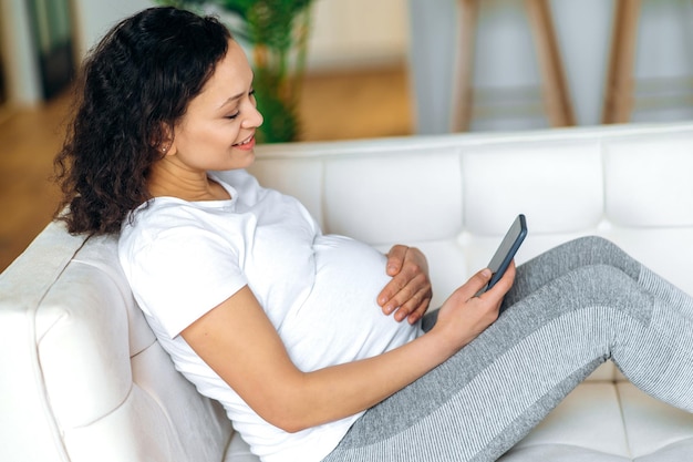 Gadget woman pregnant smartphone online chatting browsing internet