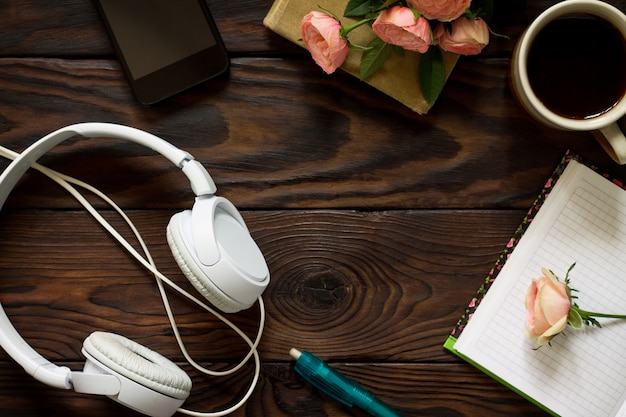 Gadgets and coffee cup on a wooden table