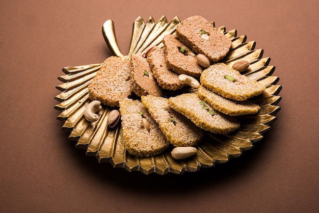 Gajak or til papdi or patti is a dry sweet cake - made of sesame seeds, ground nuts and jaggery, consumed in indian winter especially during Makar Sankranti festival on 14th january