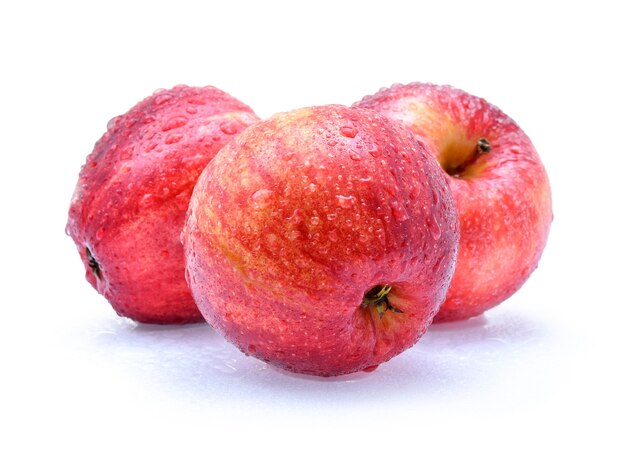 Gala apples with drops of water on white background