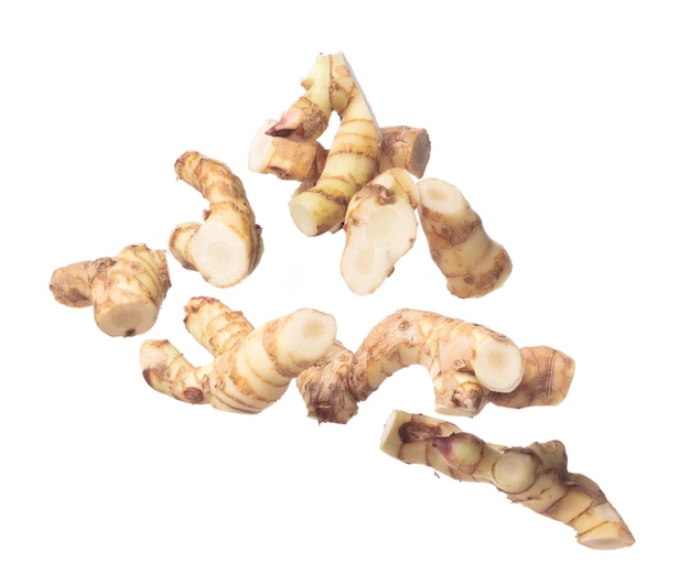 Galangal fly in mid air fresh vegetable spice galangal falling Organic fresh herbal galangal root