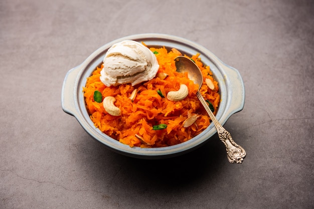 Galar halwa with vanilla ice cream, served in a bowl and garnished with dry fruits. selective focus