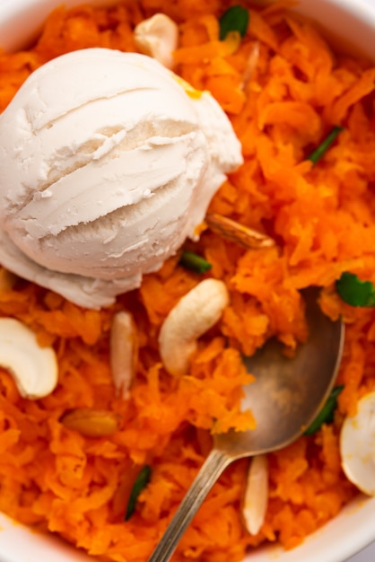 Galar halwa with vanilla ice cream, served in a bowl and garnished with dry fruits. selective focus