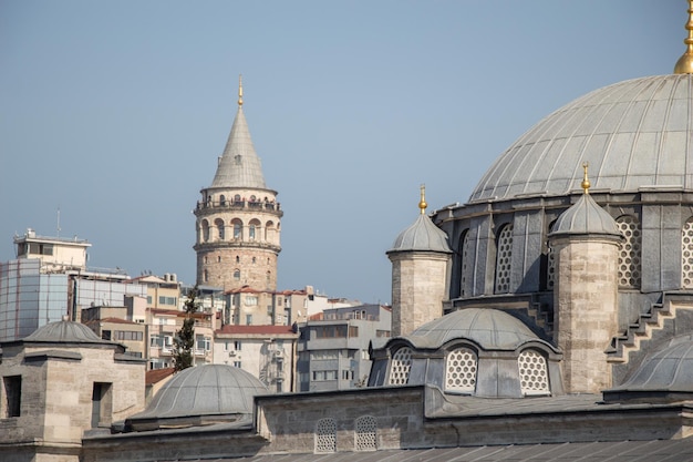 Galata tower view beside mosque dome in istanbul