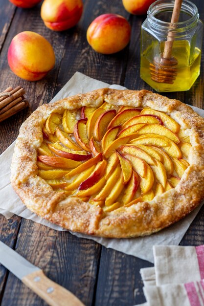 Galette or open pie with peaches. Baking. Vegetarian food.