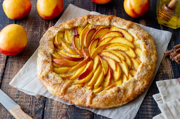 Galette or open pie with peaches. Baking. Vegetarian food.