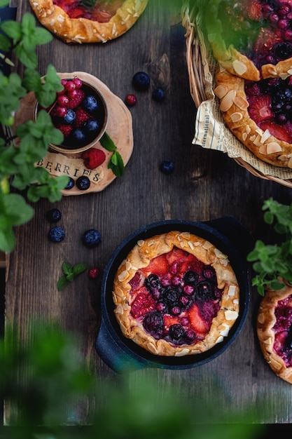 Galette with berries on rustic wooden table