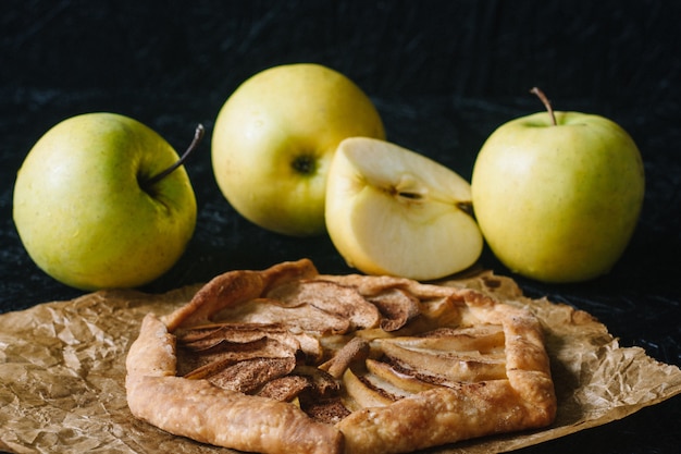 Gallet with apples on wooden board