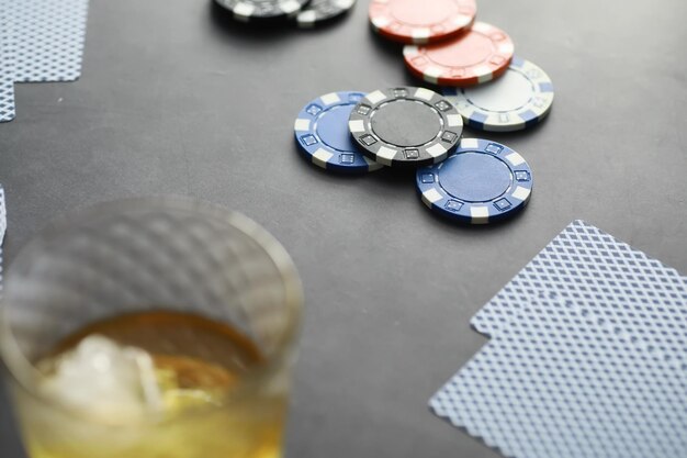 Gambling card games for money. texas hold'em poker. cards in
hand, playing chips, a deck of cards of alcohol in a glass.