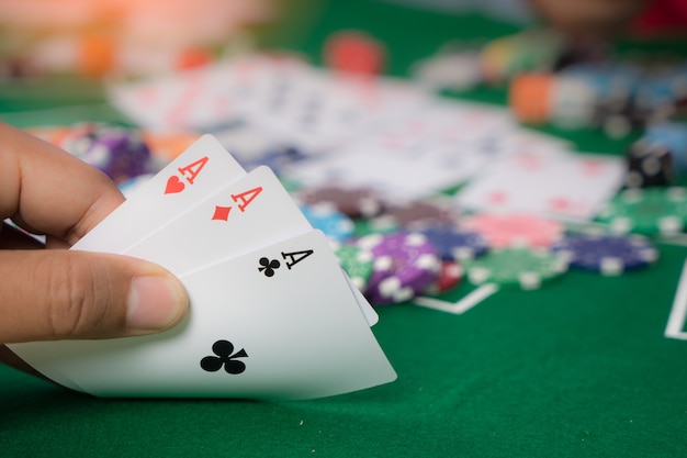 Gambling chips and cards on a green cloth Casino table