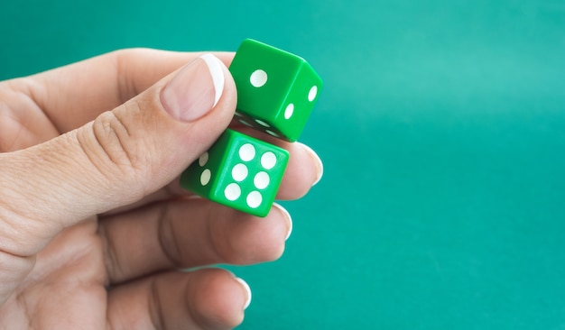 Gambling dices on green poker table