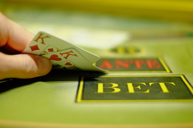 Photo gambling game of poker the player opens a combination casino interior green poker table