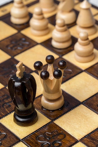 Game and chess pieces on white background