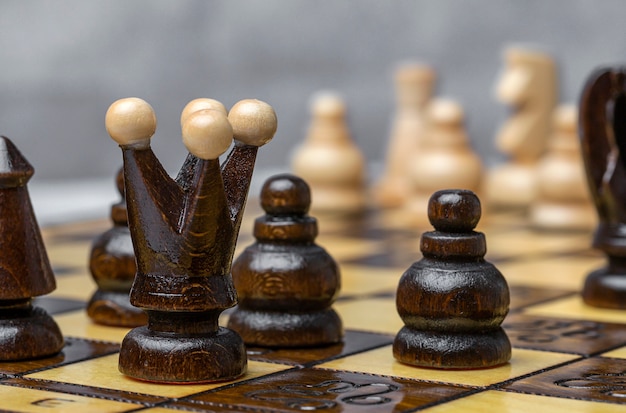 Game and chess pieces on white background