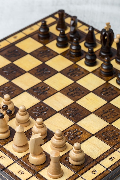 Game and chess pieces on white background