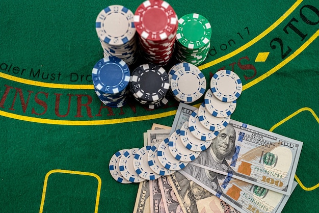 Game chips with a column of bucks of dollars laid out after the game poker concept