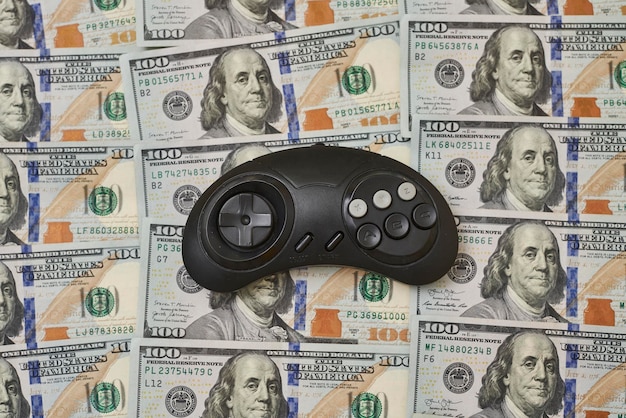 game console controller and pile of money